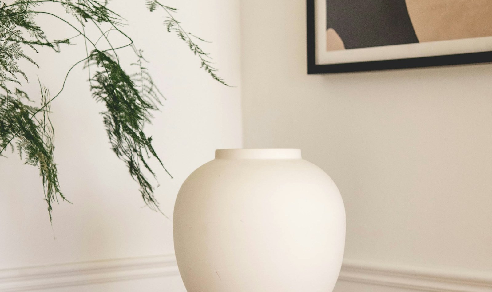 Artisanal ceramic vases and ornaments displayed on linen table